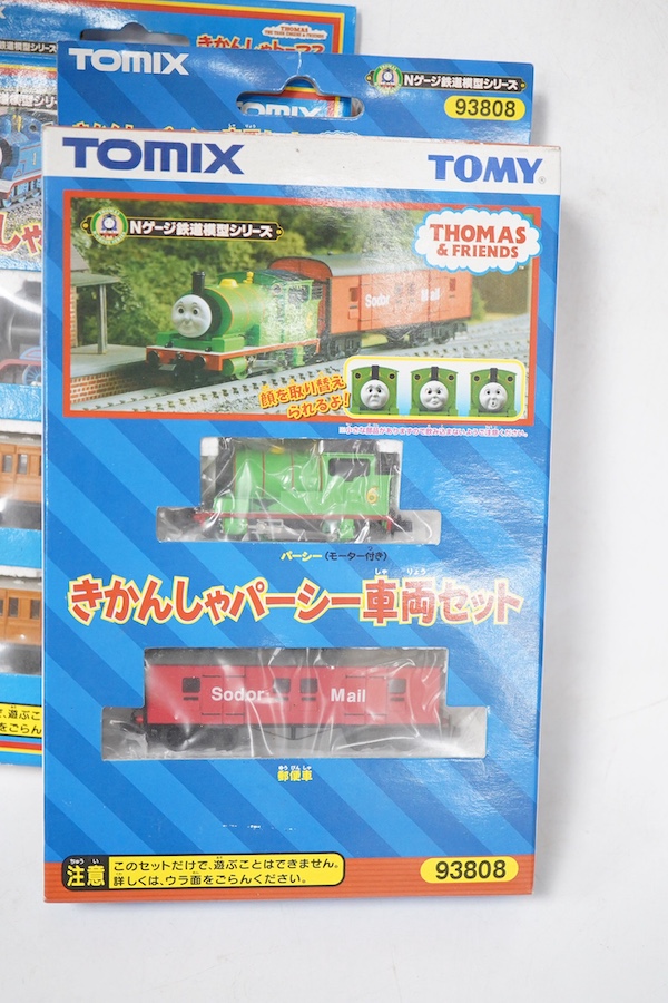 Four boxed Tomix (by Tomy) N gauge railway Thomas the Tank Engine & Friends train packs, comprising of three locomotives and rolling stock (one locomotive and a wagon missing): James (93802) - James and one wagon missing